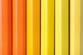 Macro photograph of several pencils of yellow and orange color o Royalty Free Stock Photo