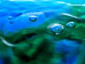 Macro photography of blue green water drop / ink drops splash and ripples, wet, conceptual for environmental, conservation, droug Royalty Free Stock Photo