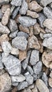 Macro photography of crushed stone and gravel of uneven shapes and sizes. Texture background light brown and gray stones with Royalty Free Stock Photo