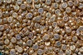 Macro photography of a heap of golden letter beads