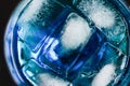 Close up of ice in drink in blue curacao colored drink Royalty Free Stock Photo