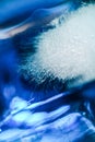 Close up of ice in drink in blue curacao colored drink Royalty Free Stock Photo
