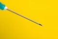 Macro photography of medical syringe needle on a yellow background. Royalty Free Stock Photo