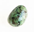 polished african turquoise stone on white