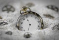 Macro photography of a old black and gold pocket watch on sand Royalty Free Stock Photo