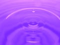 Macro photography of purple pink water drop / ink drops splash and ripples, wet, conceptual art, environmental, conservation. Royalty Free Stock Photo