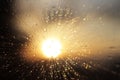Macro photography of rain drops on the glass on a blurry background of the setting sun. Texture in dark and orange tones. Blur wit Royalty Free Stock Photo