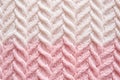 Macro photography of the texture of a knitted pattern in close-up, white and pink colors Royalty Free Stock Photo