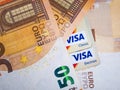 Macro picture of a 50 Euro Banknote and a Visa debit or credit card.