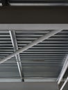 A close-up of a ceiling in a huge warehouse. Inside bright view of iron structure construction as a background.