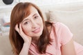 Macro portrait of smiling female face. Attractive and beautiful middle aged woman sitting on sofa and relaxing at home. Menopause. Royalty Free Stock Photo