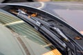 A macro portrait of a windshield wiper of a car standing at its lowest of base position and the blade is resting on the glass of Royalty Free Stock Photo