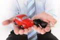 Macro red toy car with car keys in mans hand Royalty Free Stock Photo