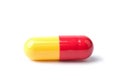Macro of red and yellow capsule pill isolated Royalty Free Stock Photo