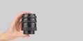 Macro rings for a camera in a male hand on a gray background Royalty Free Stock Photo