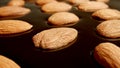 MACRO: Roasted almonds wrapped in melted dark chocolate. Close-up Royalty Free Stock Photo