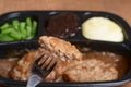 Macro salisbury steak on a fork tv dinner