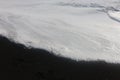 Macro sea foam on Icelandic black sand Royalty Free Stock Photo