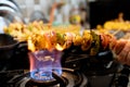 Macro selective focus shot of cottage cheese, onions, mushrooms and more on a wooden skewer roasted over an open flame Royalty Free Stock Photo