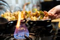 Macro selective focus shot of cottage cheese, onions, mushrooms and more on a wooden skewer roasted over an open flame Royalty Free Stock Photo