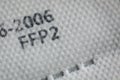 Macro and shallow depth of field image selective focus with the texture and inscriptions of a ffp2 anti covid-19 face and nose