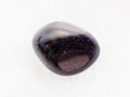 tumbled blue goldstone gemstone on white marble