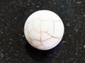 Ball from cracked Cacholong gemstone on dark Royalty Free Stock Photo