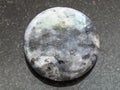 Bead from gray Labradorite gemstone on dark Royalty Free Stock Photo