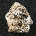 Astrophyllite crystals in rough Natrolite on dark