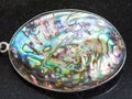 Pendant from Abalone haliotis shell on dark Royalty Free Stock Photo