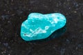 polished amazonite gemstone on dark background