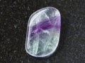 polished Fluorite gem stone on dark background