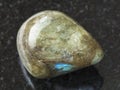 polished labradorite gem stone on dark background Royalty Free Stock Photo