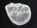 polished Ulexite gemstone on dark background