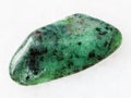 polished zoisite gemstone on white