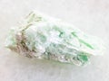raw green talc stone on white marble Royalty Free Stock Photo