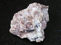 raw Miserite stone on dark background Royalty Free Stock Photo