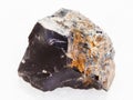 rough black Flint stone on white marble