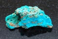 rough Chrysocolla stone on dark background