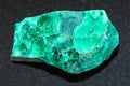 rough green malachite stone on dark background