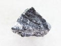 rough stibnite ore on white marble