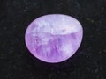 tumbled Amethyst crystal on dark background