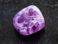 tumbled Amethyst gem on dark background