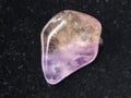 tumbled Ametrine gemstone on dark background Royalty Free Stock Photo