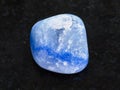 tumbled blue dyed agate gemstone on dark