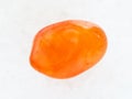 tumbled Carnelian gemstone on white marble