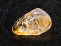 tumbled Citrine gemstone on dark background Royalty Free Stock Photo
