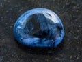 tumbled dumortierite gem stone on dark Royalty Free Stock Photo