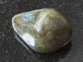 tumbled labradorite gem stone on dark background Royalty Free Stock Photo