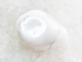 tumbled magnesite gemstone on white marble